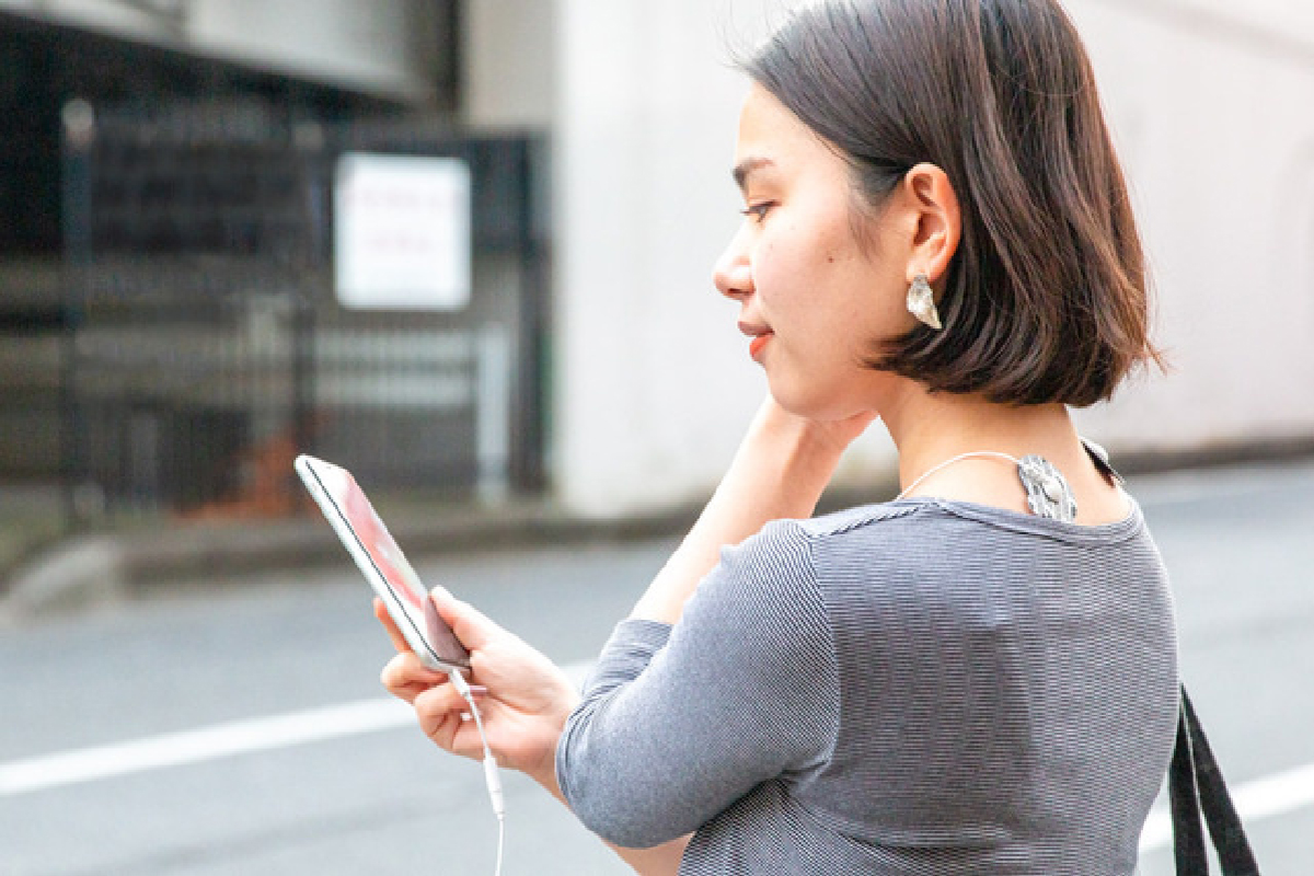 スマホ操作しながら使用する女性